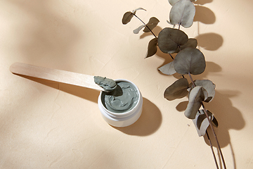 Image showing cosmetic clay mask in jar with wooden spatula