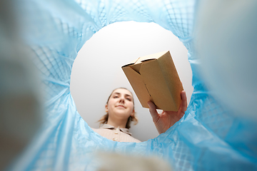 Image showing woman throwing paper box into trash can