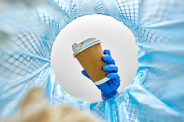 Image showing female doctor throwing coffee cup into trash can