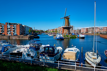 Image showing View of the harbour of Delfshaven and the old grain mill De Destilleerketel. Rotterdam, Netherlands