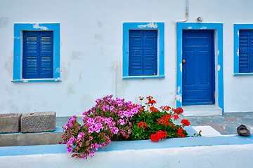 Image showing Greek white house with blue door and window blinds Oia village on Santorini island in Greece