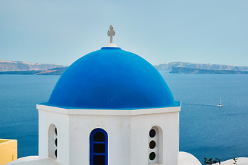 Image showing Famous view from viewpoint of Santorini Oia village with blue dome of greek orthodox Christian church