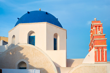 Image showing Famous view from viewpoint of Santorini Oia village with blue dome of greek orthodox Christian church