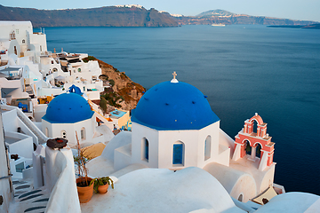 Image showing Famous view from viewpoint of Santorini Oia village with blue dome of greek orthodox Christian church