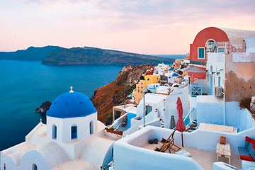 Image showing Famous view from viewpoint of Santorini Oia village with blue dome of greek orthodox Christian church