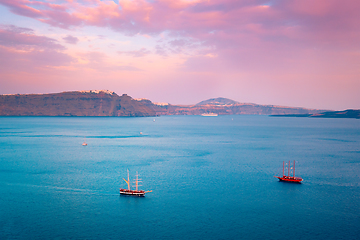 Image showing Schooner vessel ship boat in Aegean sea near Santorini island with tourists going to sunset viewpoint