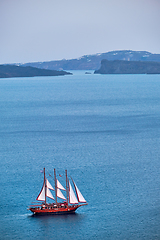 Image showing Schooner vessel ship boat in Aegean sea near Santorini island with tourists going to sunset viewpoint