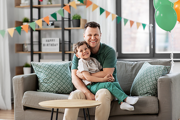 Image showing happy father and little son at home birthday party