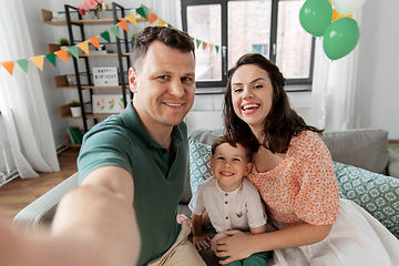 Image showing happy family taking selfie on birthday at home