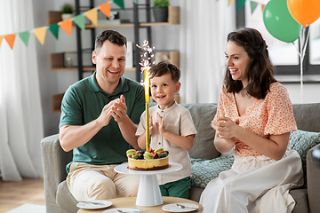 Image showing happy family with birthday cake at home