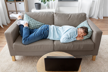 Image showing young man sleeping on sofa at home