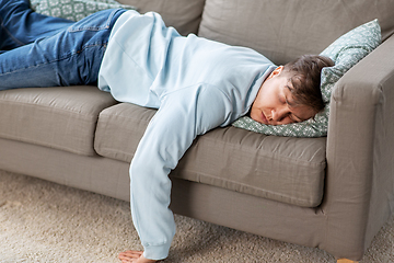 Image showing young man sleeping on sofa at home