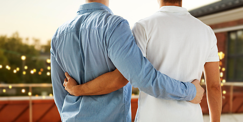 Image showing close up of happy male gay couple hugging at party