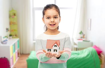 Image showing smiling girl holding house model