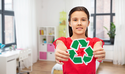 Image showing smiling girl holding green recycling sign