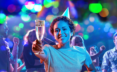 Image showing african woman in party cap with glass of champagne