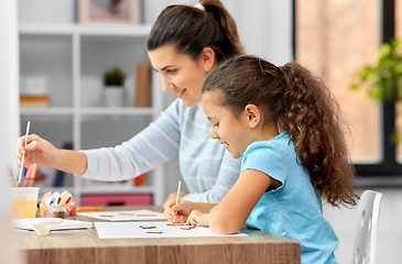 Image showing happy mother with little daughter drawing at home