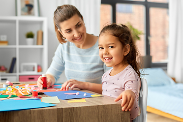 Image showing daughter with mother making applique at home