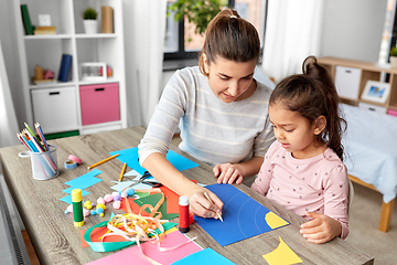 Image showing daughter with mother making applique at home