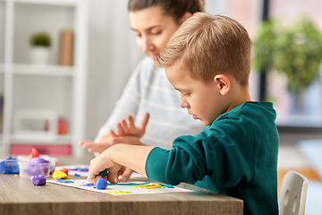 Image showing mother and son playing with modeling clay at home