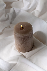 Image showing burning aroma candle on white sheet