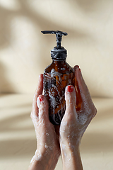 Image showing hands with bottle of shower gel or liquid soap