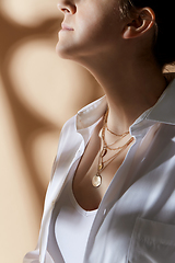 Image showing close up of woman with golden jewelry on her neck