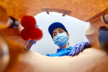 Image showing delivery girl in gloves and mask with food in bag