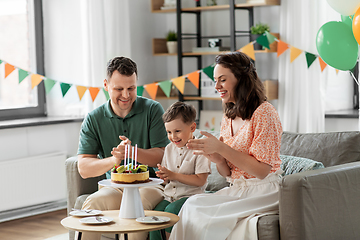 Image showing happy family with birthday cake at home