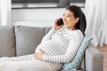 Image showing happy pregnant woman calling on smartphone at home