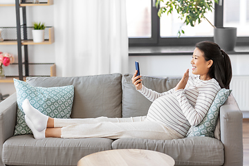 Image showing happy pregnant woman having video call on phone