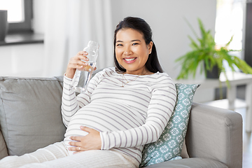 Image showing pregnant woman with water in glass bottle at home