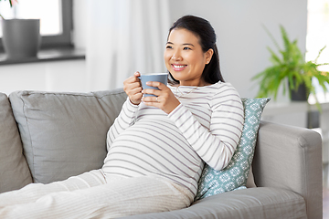 Image showing happy pregnant woman drinking tea at home