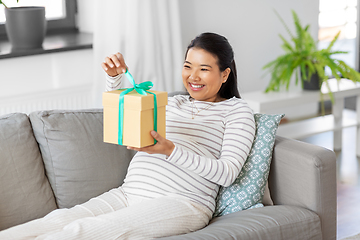 Image showing happy pregnant woman with gift box at home