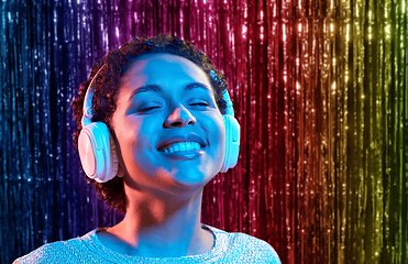 Image showing african woman in headphones listening to music