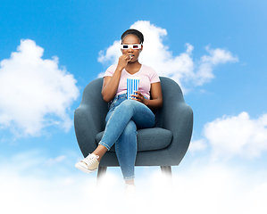 Image showing woman in 3d movie glasses eating popcorn in chair