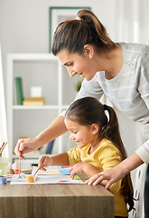 Image showing mother with little daughter drawing at home