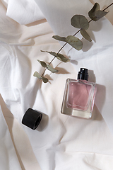 Image showing bottle of perfume and on white sheet