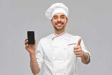 Image showing happy chef with smartphone showing and thumbs up