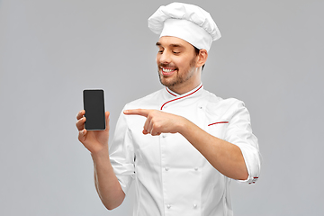 Image showing happy smiling male chef showing smartphone