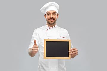 Image showing happy male chef showing chalkboard and thumbs up