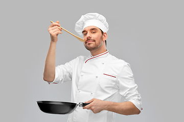 Image showing happy male chef with frying pan tasting food