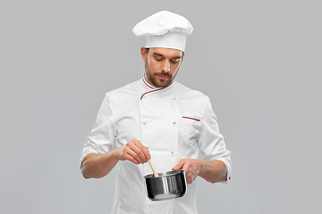 Image showing male chef with saucepan cooking food