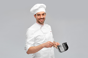 Image showing happy smiling male chef with saucepan cooking food