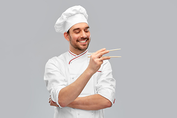 Image showing happy smiling male chef with chopsticks