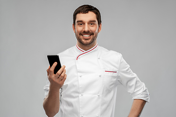 Image showing happy smiling male chef with smartphone