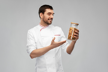 Image showing happy smiling male chef with pasta in glass jar