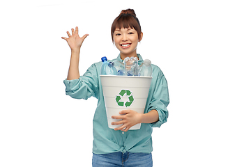 Image showing smiling young asian woman sorting plastic waste