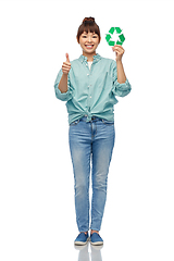 Image showing smiling asian woman holding green recycling sign