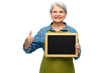 Image showing senior gardener with chalkboard showing thumbs up